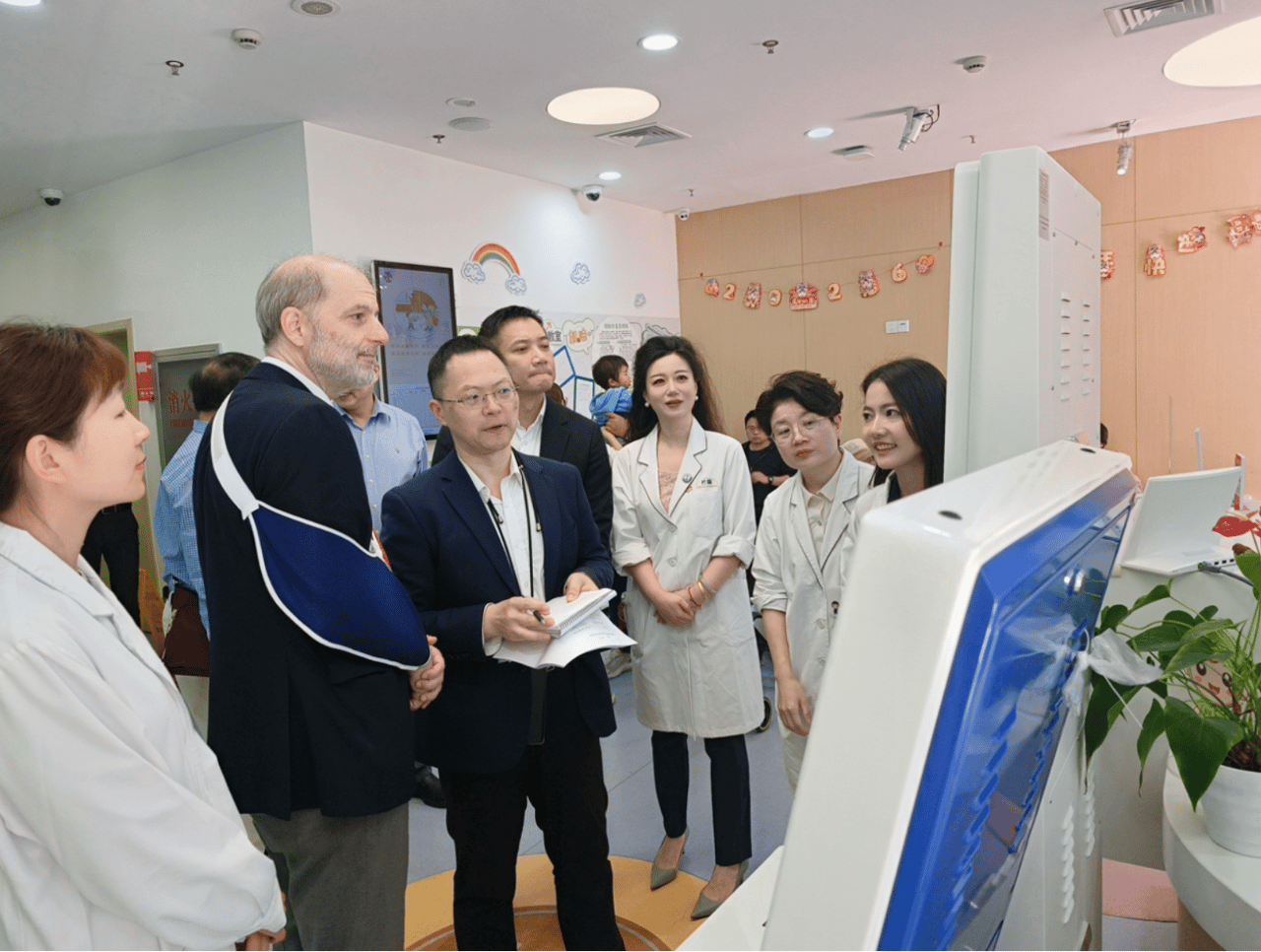 WONCA assessors view a digital service display with Dapuqiao Community Health Service Centre staff during the on-site visit